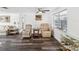 Comfortable living room features wood-look flooring, recliners, and a well-lit atmosphere at 6422 Tralee Ave, New Port Richey, FL 34653