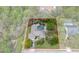 A beautiful aerial shot shows the home, featuring a screened pool and lush, mature landscaping at 6475 Laurel Oak Dr, Spring Hill, FL 34607
