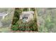 Aerial shot highlighting a home's private pool surrounded by a dense canopy of trees at 6475 Laurel Oak Dr, Spring Hill, FL 34607