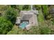 Bird's-eye view showcasing a home with a screened pool and lush trees at 6475 Laurel Oak Dr, Spring Hill, FL 34607