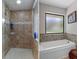 This bathroom features a glass enclosed shower and a separate soaking tub at 6475 Laurel Oak Dr, Spring Hill, FL 34607