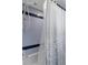 Shower with blue and white tile, handheld shower head, and shower curtain at 6475 Laurel Oak Dr, Spring Hill, FL 34607
