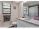 Bright bathroom featuring dual windows, sleek vanity, and modern fixtures at 6475 Laurel Oak Dr, Spring Hill, FL 34607