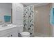 This cozy bathroom offers a vanity sink and shower with decorative shower curtain and wall decor at 6475 Laurel Oak Dr, Spring Hill, FL 34607