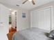 Bedroom with wood floors, double closet, and adjacent view of the bathroom and backyard at 6475 Laurel Oak Dr, Spring Hill, FL 34607