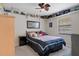 Bedroom with a ceiling fan, neutral color palette, shelves, and a comfortable bed at 6475 Laurel Oak Dr, Spring Hill, FL 34607