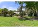 Exterior of the home with lush landscaping and mature trees at 6475 Laurel Oak Dr, Spring Hill, FL 34607