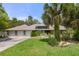 Charming single-story home with a three-car garage, a large manicured lawn, and mature landscaping at 6475 Laurel Oak Dr, Spring Hill, FL 34607