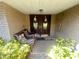 Cozy front porch featuring a double door entry, wicker furniture and decorative plants at 6475 Laurel Oak Dr, Spring Hill, FL 34607