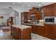 Spacious kitchen with custom wood cabinetry, granite countertops, an island, and stainless steel appliances at 6475 Laurel Oak Dr, Spring Hill, FL 34607