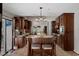 A traditional kitchen features dark wood cabinets, granite countertops, and a central island with seating at 6475 Laurel Oak Dr, Spring Hill, FL 34607