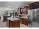 Well-appointed kitchen boasts an island, stainless steel refrigerator, wine rack, and lovely views of the outdoor pool at 6475 Laurel Oak Dr, Spring Hill, FL 34607