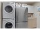 Modern laundry room equipped with stacked washer/dryer and storage, offering convenience and organization at 6475 Laurel Oak Dr, Spring Hill, FL 34607