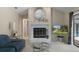 Comfortable living room featuring a fireplace, television, and sliding glass door to the lanai at 6475 Laurel Oak Dr, Spring Hill, FL 34607