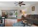 Bright living room featuring wood floors with views of the pool and patio at 6475 Laurel Oak Dr, Spring Hill, FL 34607