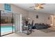 Living room with a desk, sofa, and view of the pool area through a sliding glass door at 6475 Laurel Oak Dr, Spring Hill, FL 34607