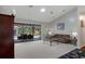 Elegant living room with large glass doors offering serene views of the backyard pool area at 6475 Laurel Oak Dr, Spring Hill, FL 34607