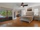 Spacious main bedroom with hardwood floors, natural light, and access to the pool area at 6475 Laurel Oak Dr, Spring Hill, FL 34607