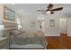 This spacious bedroom features hardwood floors, a ceiling fan, and ensuite bath access at 6475 Laurel Oak Dr, Spring Hill, FL 34607
