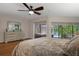 Bright main bedroom with view of the pool, comfortable furnishings, and wood flooring at 6475 Laurel Oak Dr, Spring Hill, FL 34607