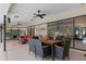 Covered outdoor patio with a dining set and outdoor furniture perfect for entertaining near the pool at 6475 Laurel Oak Dr, Spring Hill, FL 34607
