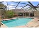A serene screened pool boasts a spacious deck with outdoor seating, perfect for entertaining and relaxation at 6475 Laurel Oak Dr, Spring Hill, FL 34607