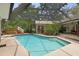 Enjoy this sparkling pool surrounded by lush foliage, screened-in patio, and hot tub at 6475 Laurel Oak Dr, Spring Hill, FL 34607