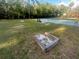 This community features a recreation area with a tennis court, horseshoe pit, and a bench under the shade trees at 6475 Laurel Oak Dr, Spring Hill, FL 34607