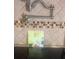 Close up of a kitchen stovetop with tile backsplash and chef-inspired decoration at 6475 Laurel Oak Dr, Spring Hill, FL 34607