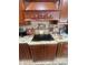 Detail of a kitchen stovetop with decorative accents and custom cabinetry at 6475 Laurel Oak Dr, Spring Hill, FL 34607