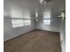 Large finished basement featuring newer carpet, updated lighting, and windows at 6819 Treehaven Dr, Spring Hill, FL 34606