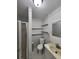 Clean and functional bathroom with white fixtures, built-in shelves, and walk-in shower at 6819 Treehaven Dr, Spring Hill, FL 34606