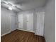 Bedroom featuring ceiling fan, closet and laminate flooring at 6819 Treehaven Dr, Spring Hill, FL 34606