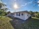 Side view of this single-story home with manicured lawn and tasteful exterior design at 6819 Treehaven Dr, Spring Hill, FL 34606