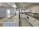 Well-maintained kitchen with white cabinets, countertop seating, and modern appliances at 6819 Treehaven Dr, Spring Hill, FL 34606