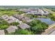 Aerial view of the neighborhood showcasing the community's pond and well-maintained landscaping and attractive houses at 6821 Breezy Palm Dr, Riverview, FL 33578