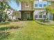 Green backyard with a screened patio, perfect for enjoying the outdoors in a private setting at 6821 Breezy Palm Dr, Riverview, FL 33578