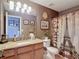 Bathroom featuring a granite countertop, framed mirror, and a Paris themed shower curtain at 6821 Breezy Palm Dr, Riverview, FL 33578