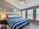 Bedroom featuring neutral walls, a king bed, a ceiling fan, and large windows at 6821 Breezy Palm Dr, Riverview, FL 33578