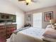 Bedroom featuring neutral walls, a queen bed, a ceiling fan, and a dresser at 6821 Breezy Palm Dr, Riverview, FL 33578