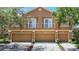 Charming townhouse with a multi-car garage, tan exterior, and delightful balcony spaces at 6821 Breezy Palm Dr, Riverview, FL 33578
