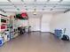 Spacious two-car garage with epoxy flooring and overhead storage racks for organization at 6821 Breezy Palm Dr, Riverview, FL 33578