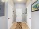 Neutral hallway with a decorative rug, white doors, and light gray walls at 6821 Breezy Palm Dr, Riverview, FL 33578