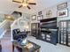 Cozy living room with television, bookcase, and stairs to the second floor at 6821 Breezy Palm Dr, Riverview, FL 33578