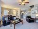 Inviting living room featuring a ceiling fan, comfortable seating, and stairs to the second floor at 6821 Breezy Palm Dr, Riverview, FL 33578
