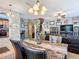 Open living space with dining area, a large sectional, and a staircase to the upper level at 6821 Breezy Palm Dr, Riverview, FL 33578