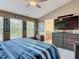 Comfortable bedroom featuring two large windows, and a large television screen above the dresser at 6821 Breezy Palm Dr, Riverview, FL 33578