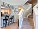 Stairwell to second floor with view of kitchen and bar at 6821 Breezy Palm Dr, Riverview, FL 33578