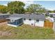 Aerial view of home featuring a screened lanai, fenced backyard, and mature trees at 7034 N King Arthur E Dr # 4, Port Richey, FL 34668