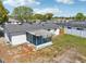 Aerial view of the property highlighting the screened lanai, fenced backyard, and proximity to neighboring homes at 7034 N King Arthur E Dr # 4, Port Richey, FL 34668